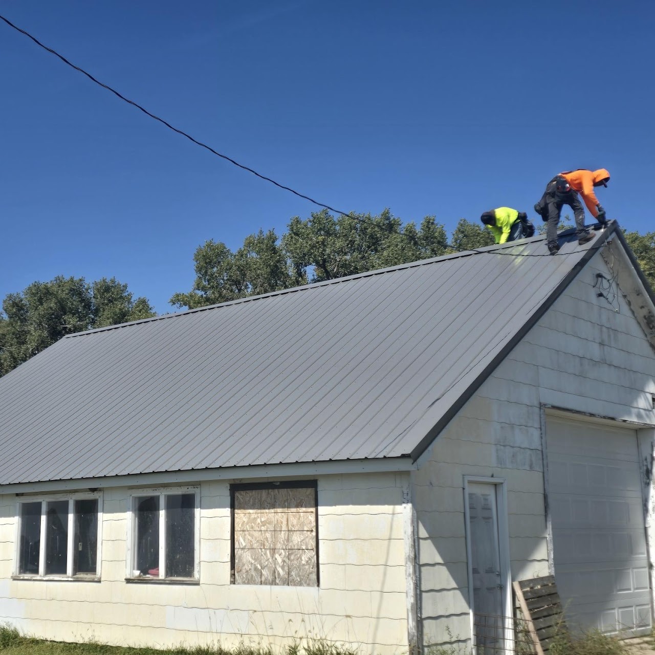Metal roofing crew on commercial building — GGR Exteriors Fremont NE